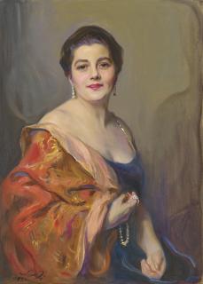 Philip Alexius De László - Portrait of Mrs Robert Celestin Guinness (Dickie), seated half-length, wearing a red brocade stole over her black velvet dress, drop earrings and holding her pearl necklace in her right hand