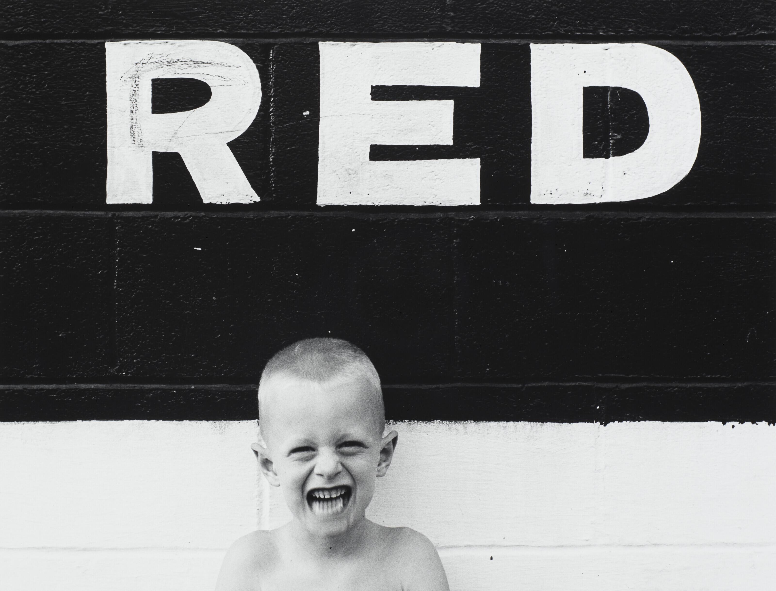 Ralph Eugene Meatyard - Untitled (Boy with Sign \'Red\'), 1955