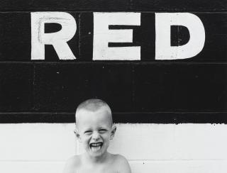Ralph Eugene Meatyard - Untitled (Boy with Sign \'Red\'), 1955