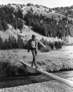 Robert Capa - Gary Cooper crossing the river during a hunting trip with Ernest Hemingway, Sun Valley, Idaho