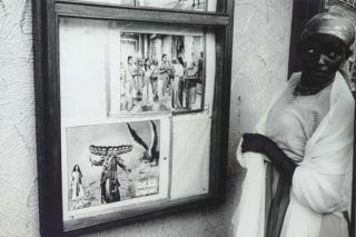 Robert Frank - Untitled (Woman looking at Indian Movie Posters), c. 1965