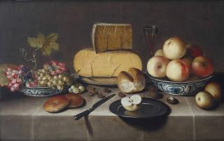 Roelof Koets - Cheese on a silver plate, red and white grapes and apples in porcelain Wanli bowls, bread rolls, a knife and a sliced apple on a plate, all on a draped table