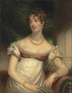 Sir William Beechey, R.A. - Portrait Of Miss Anne Lee, Half-Length, In A White Dress, With A Gold Necklace And Bracelets, Pearls In Her Hair, A Book In Her Right Hand, In An Interior