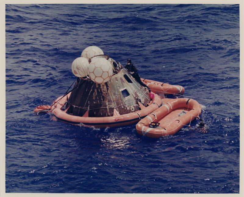 The United States Navy Underwater Demolition Team swimmer assists the Apollo 12 crew during recovery operations in the Pacific Ocean