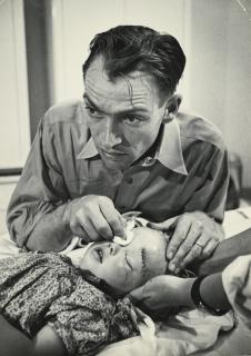 W. Eugene Smith - Dr. Ernest Ceriani Holding Compress On Child\'S Eye, From Country Doctor Essay