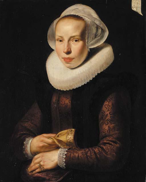 Werner Van Den Valckert - Portrait of a lady, aged 30, half-length, in an embroidered burgundy bodice, with a white ruff and white cap, a glove in her right hand