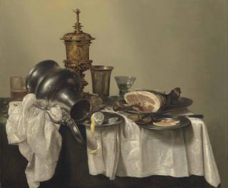 Willem Claesz. Heda - A leg of ham, a partly-peeled lemon and slices of bread on pewter platters, a berkemeier, an upturned tankard, a silver-gilt cup and cover, and other vessels on a partly-draped table