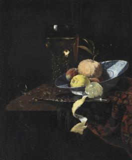 Willem Kalf - A Roemer, A Glass Flute, An Orange, Two Peaches And A Lemon In A Blue And White Wanli Kraak Charger With A Knife And A Partially Peeled Lemon On A Silver Platter, All On A Partially Draped Stone Ledge