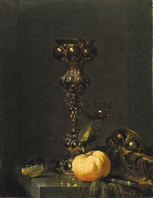 Willem Kalf - A steeple cup with upturned cover, a glass of wine, an orange and a knife on an Oriental rug on a draped marble ledge
