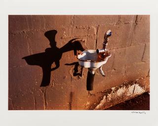William Eggleston - Untitled (drinking fountain / brown wall)